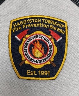 Embroidered patch with merrow border on fabric